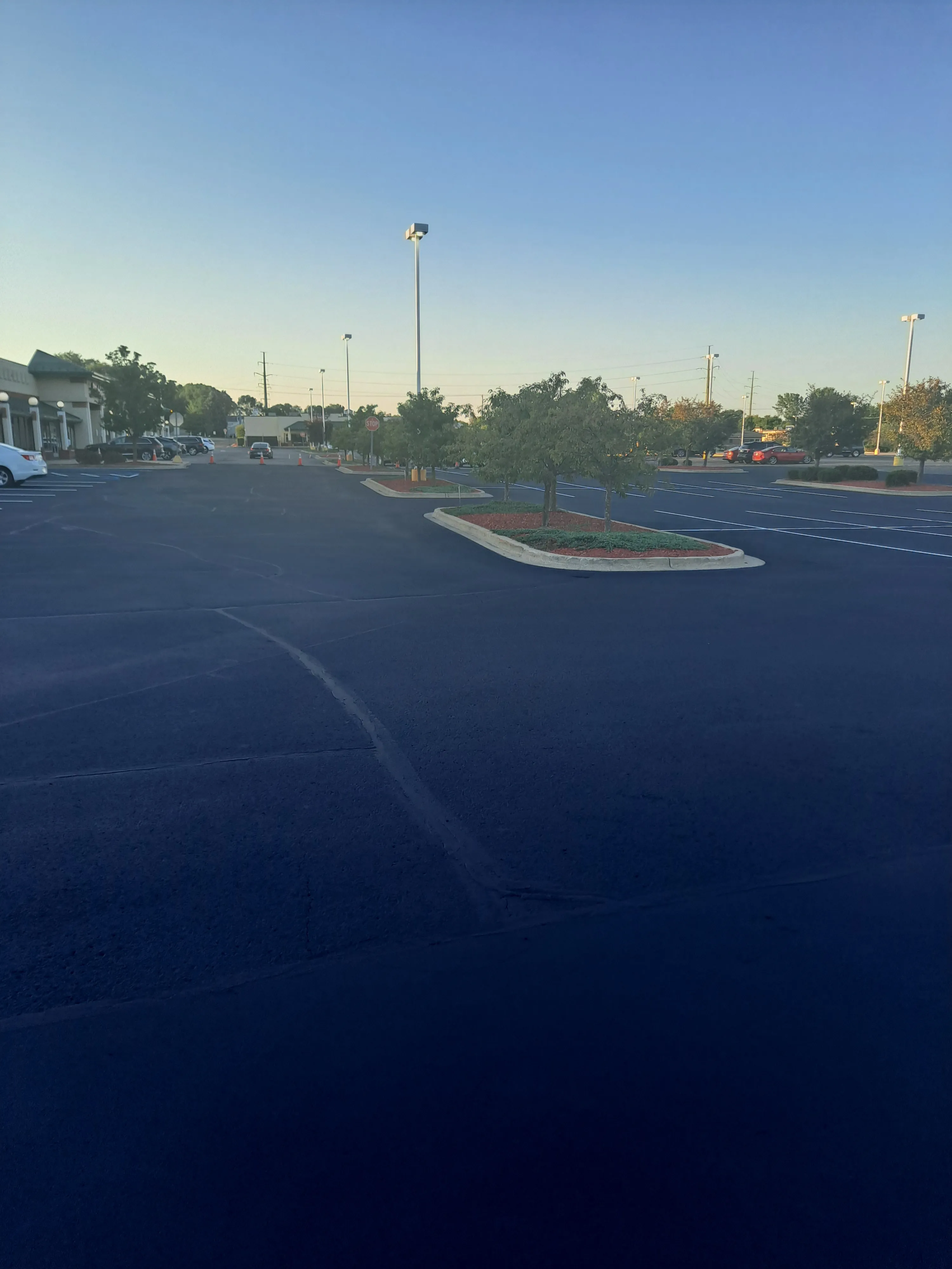 Commercial parking lot protected and freshly sealed at dusk
